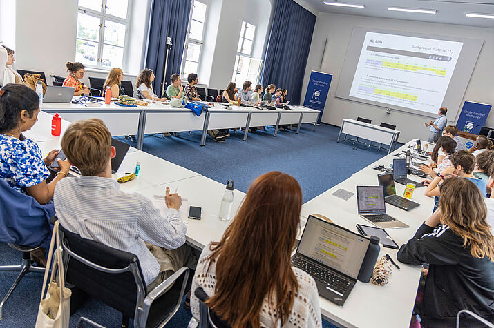 Participants sitting in u-shape and listen to Fabian Wagner from IIASA.
